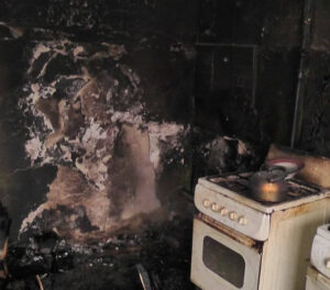 Fire and water damage restoration service cleaning and repairing a damaged home interior