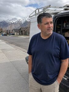 IICRC certified restoration technician inspecting wall moisture in Utah home